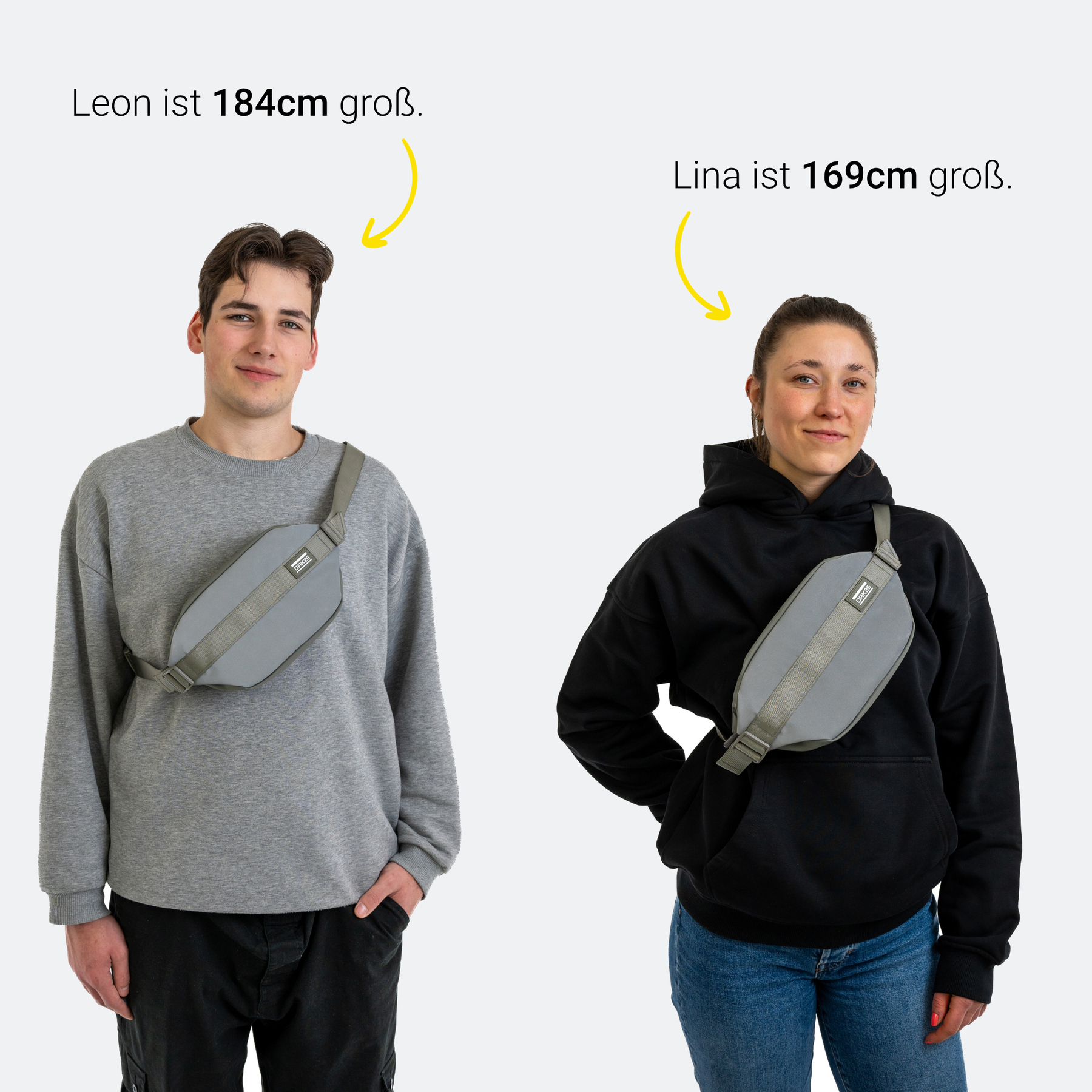 Mann (184 cm) und Frau (169 cm) tragen reflektierende salbeifarbene Carry All Sling Taschen quer über die Brust