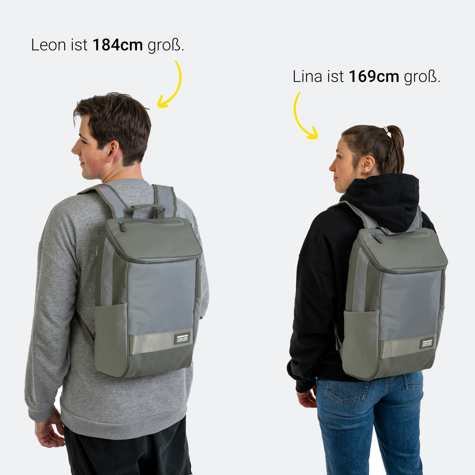Junge und Mädchen tragen einen salbeigrünen Daybag-Rucksack mit reflektierenden Streifen, um Größenvergleich bei 184 cm und 169 cm zu zeigen