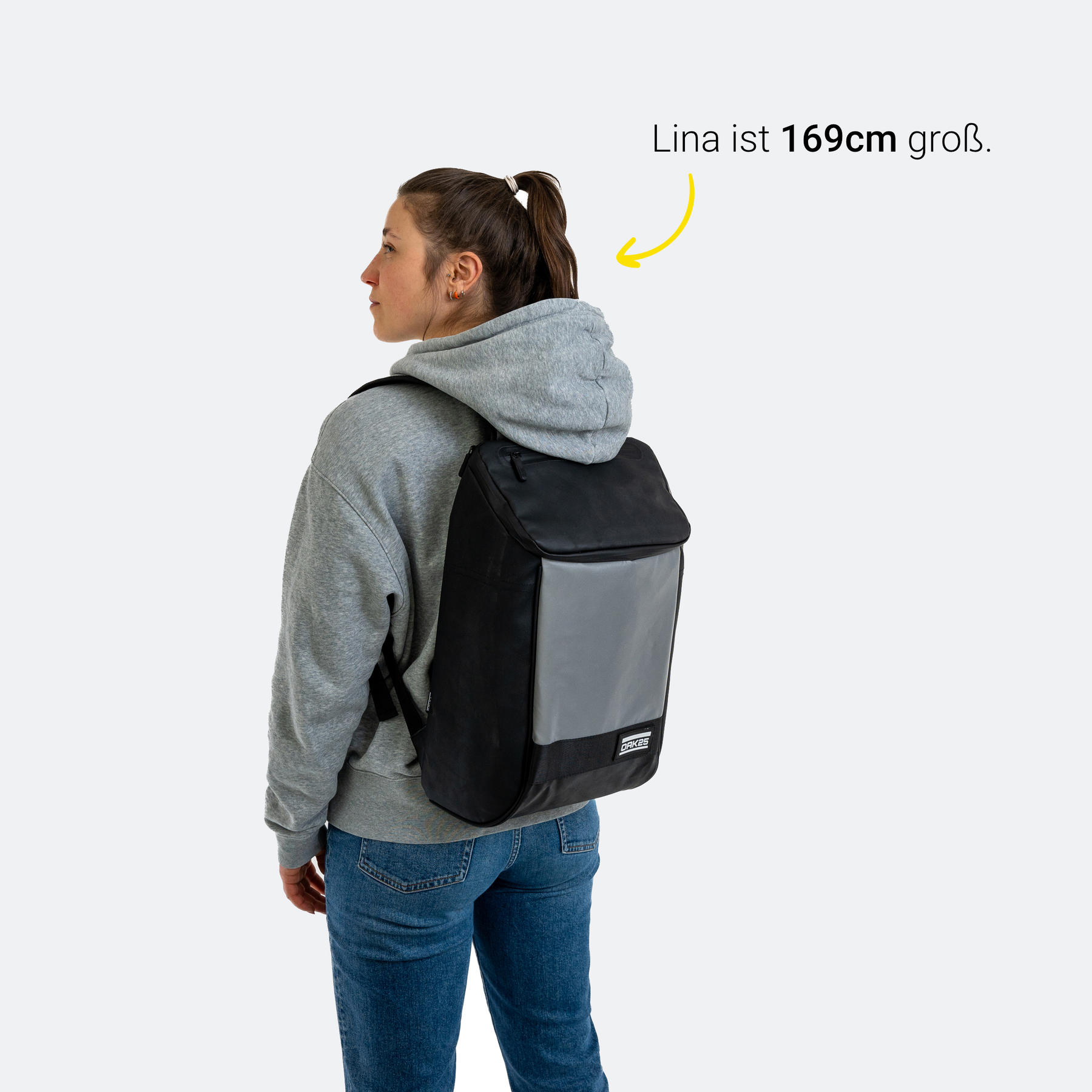 Frau mit 169 cm trägt schwarzen OAK25 Daybag mit reflektierender Fronttasche