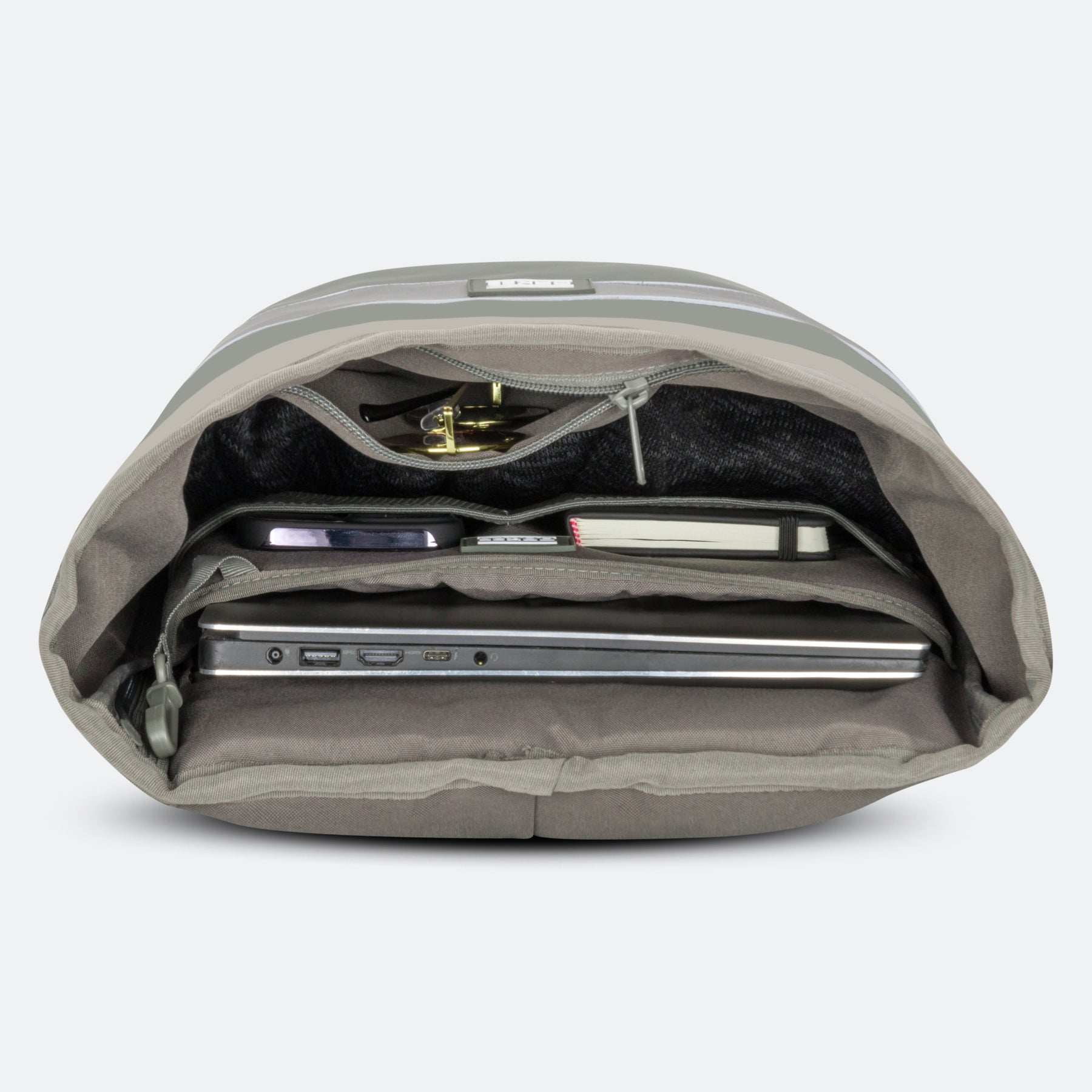 Salbei-farbener Rolltop-Rucksack geöffnet, mit Laptop, Notizbuch, Handy und Schlüssel in verschiedenen Fächern
