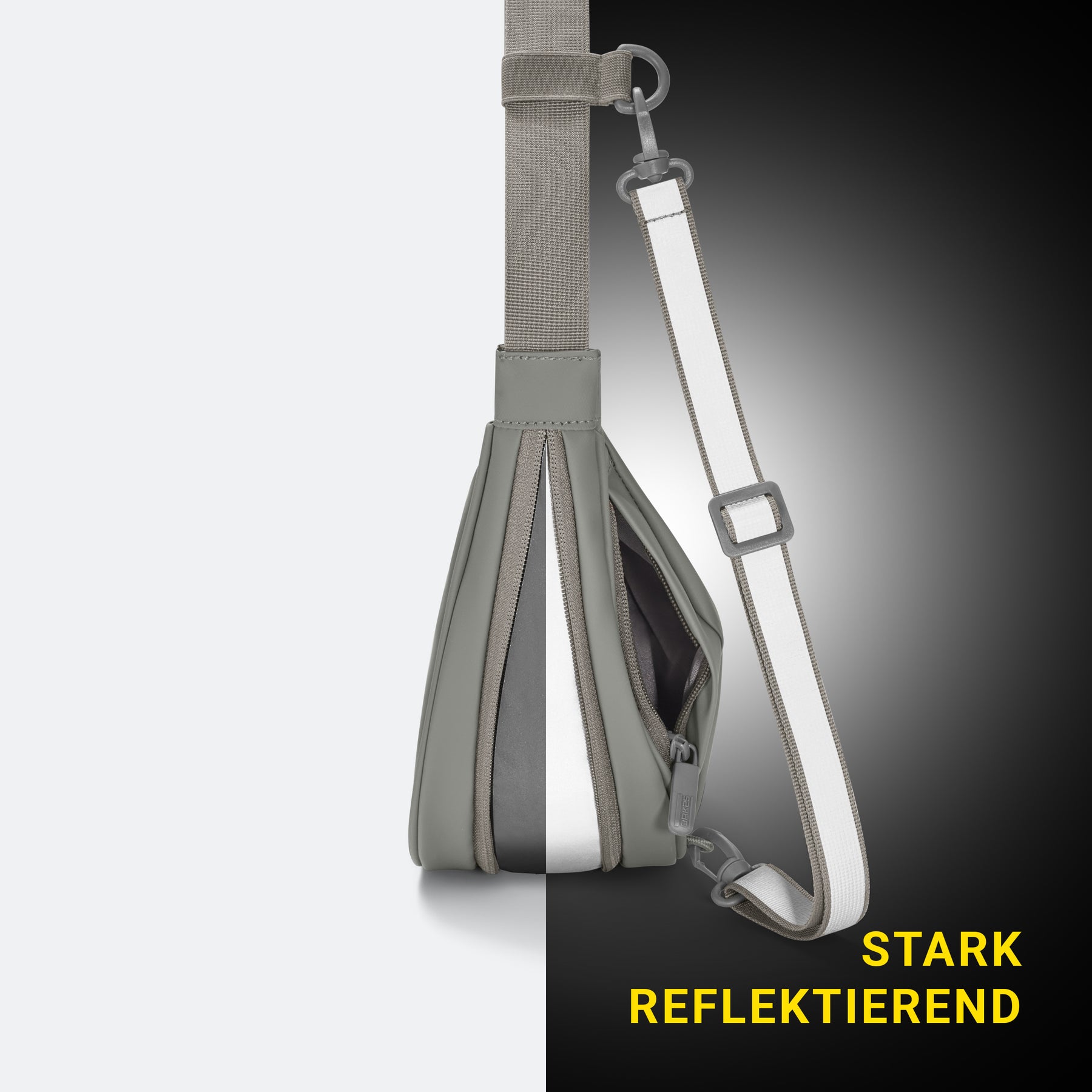 Salbeigrüne Halbmondtasche mit reflektierendem Riemen, gezeigt bei unterschiedlicher Beleuchtung