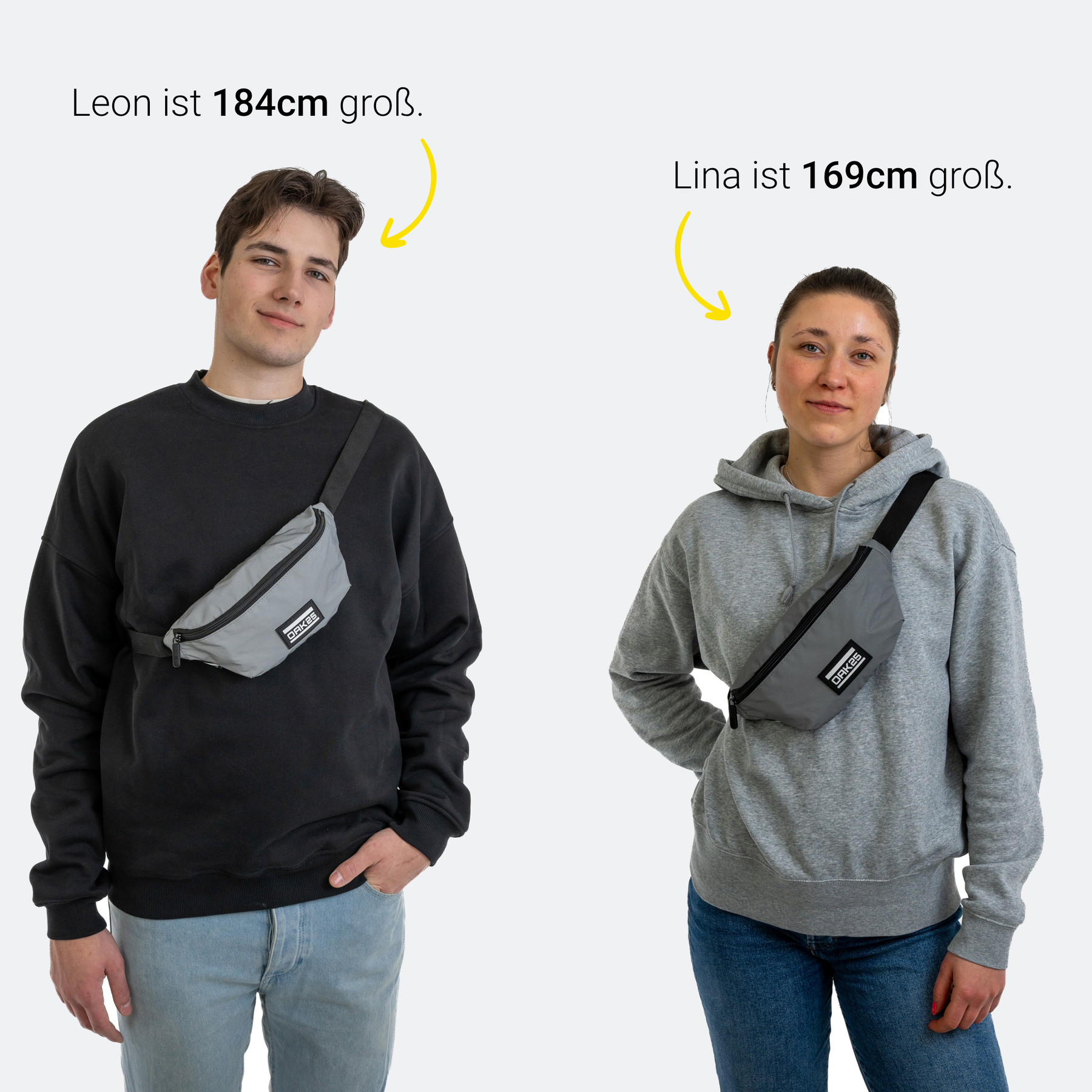 Junge und junge Frau tragen reflektierende graue OAK25 Sling Taschen, Leon ist 184 cm groß, Lina ist 169 cm groß